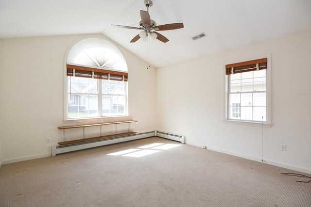 carpeted spare room with a ceiling fan, visible vents, vaulted ceiling, baseboards, and a baseboard heating unit