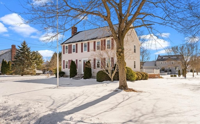 colonial home with a chimney and a residential view