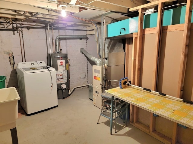 basement featuring gas water heater, sink, washer / clothes dryer, and heating unit