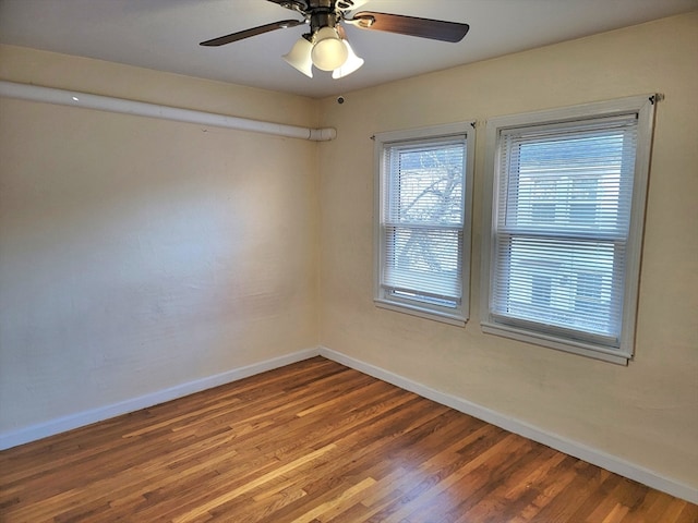 empty room with ceiling fan and hardwood / wood-style flooring