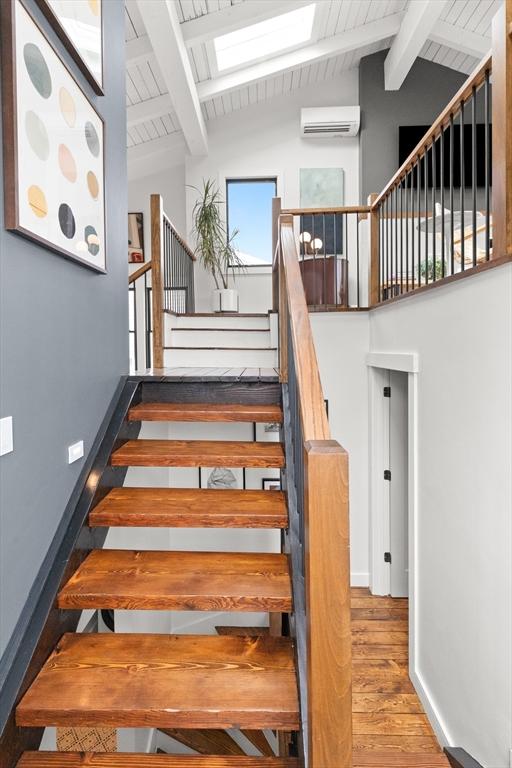9 Upland Rd, Marblehead, MA 01945 - stairs with wood finished floors, a wall mounted AC, wooden ceiling, and baseboards