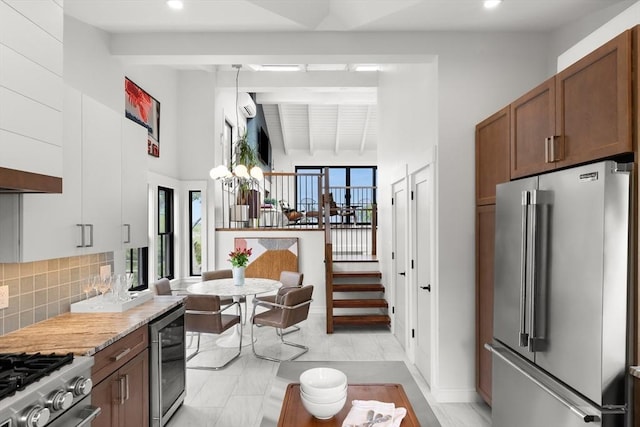 9 Upland Rd, Marblehead, MA 01945 - kitchen with high end refrigerator, beverage cooler, recessed lighting, beam ceiling, and backsplash