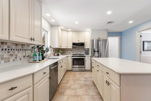 kitchen featuring stainless steel appliances, sink, and decorative backsplash