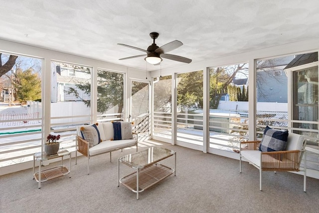 sunroom / solarium featuring ceiling fan