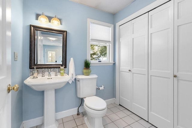 bathroom with sink, tile patterned floors, and toilet