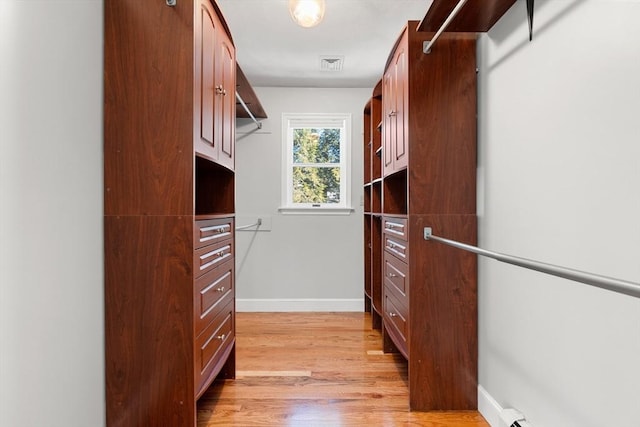 spacious closet featuring light hardwood / wood-style flooring