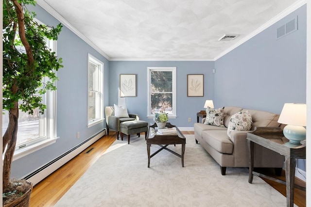 living room featuring crown molding, a baseboard heating unit, and light hardwood / wood-style flooring