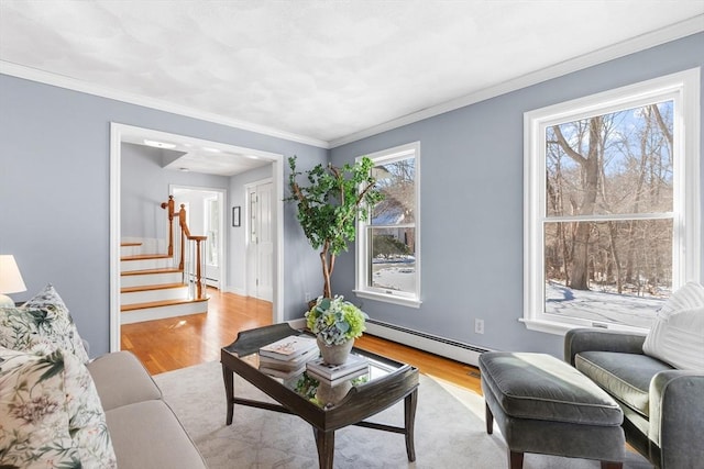 living room featuring a baseboard radiator, crown molding, and light hardwood / wood-style floors