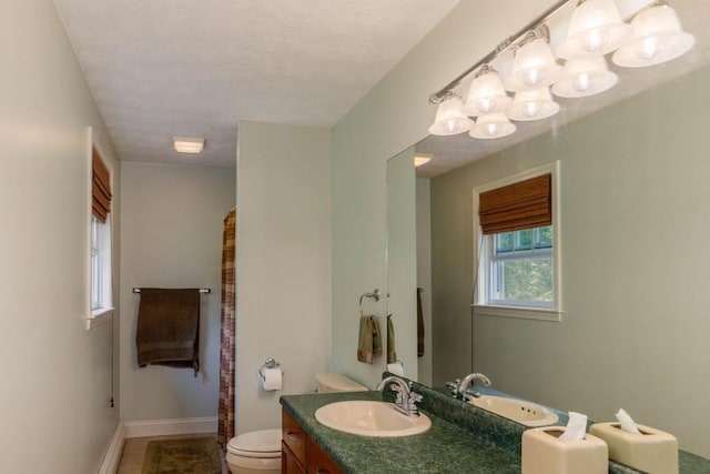 20 Starling Way, Leominster, MA 01453 - bathroom with toilet, vanity, tile patterned flooring, baseboards, and a chandelier