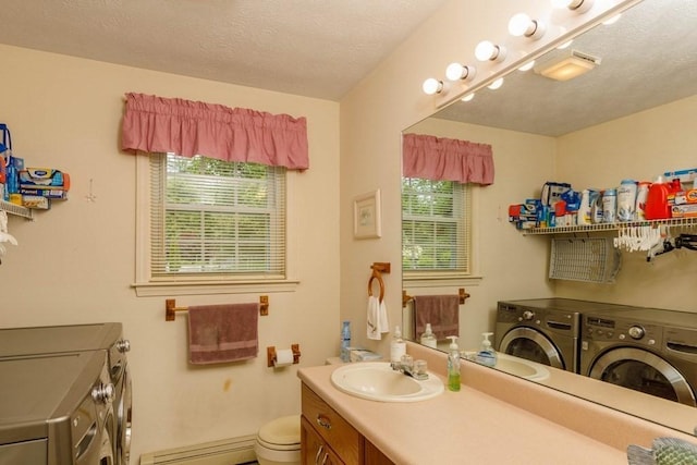 20 Starling Way, Leominster, MA 01453 - bathroom featuring washer and dryer, baseboard heating, vanity, toilet, and a textured ceiling