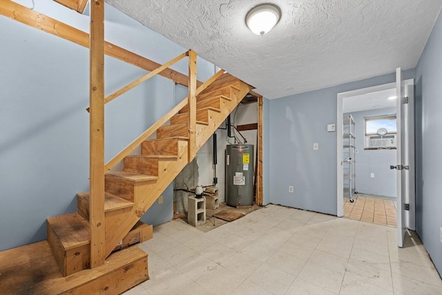 below grade area featuring water heater, stairway, a textured ceiling, and tile patterned floors