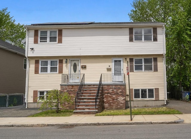 view of front of home featuring fence