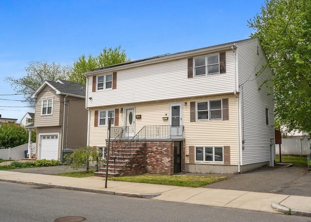 view of front of home featuring a garage and fence