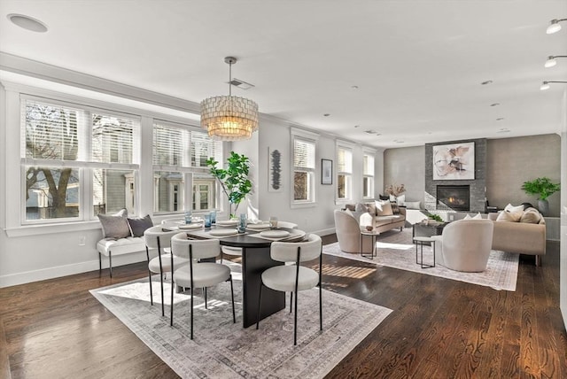 dining room with dark hardwood / wood-style flooring and an inviting chandelier