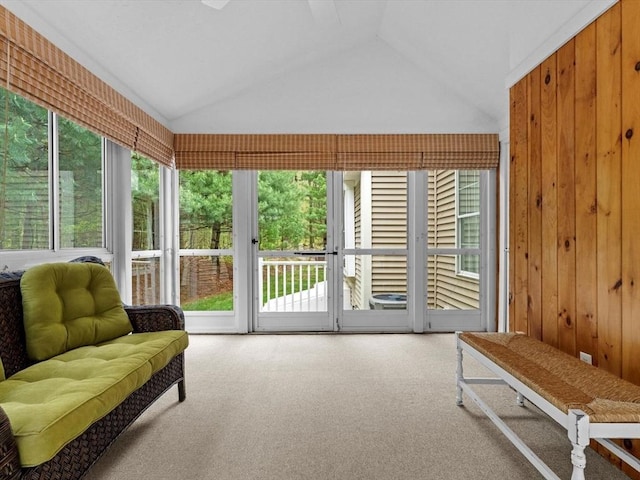 sunroom / solarium with carpet flooring, lofted ceiling, and healthy amount of natural light