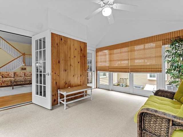 sitting room featuring carpet flooring, a ceiling fan, stairway, and lofted ceiling