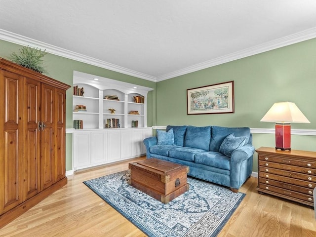 living room featuring light wood finished floors and ornamental molding