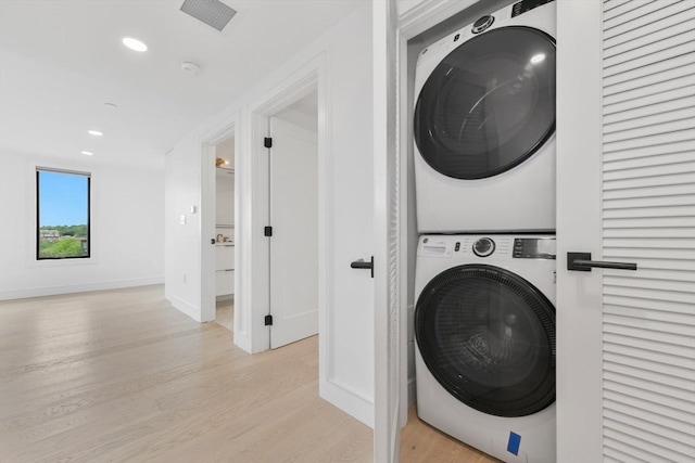50 Leo M Birmingham Pkwy Unit 509, Boston, MA 02135 - washroom featuring stacked washer / dryer, light wood-style floors, recessed lighting, and baseboards