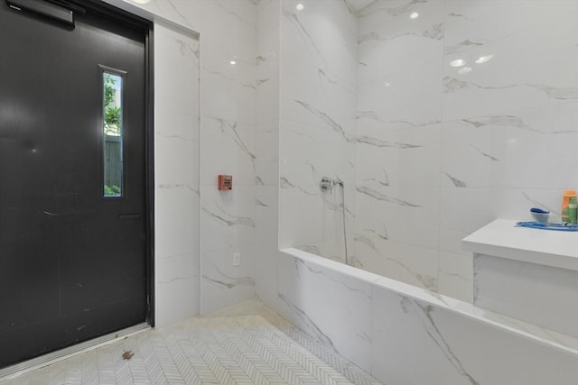50 Leo M Birmingham Pkwy Unit 509, Boston, MA 02135 - full bathroom with tile walls and a marble finish shower