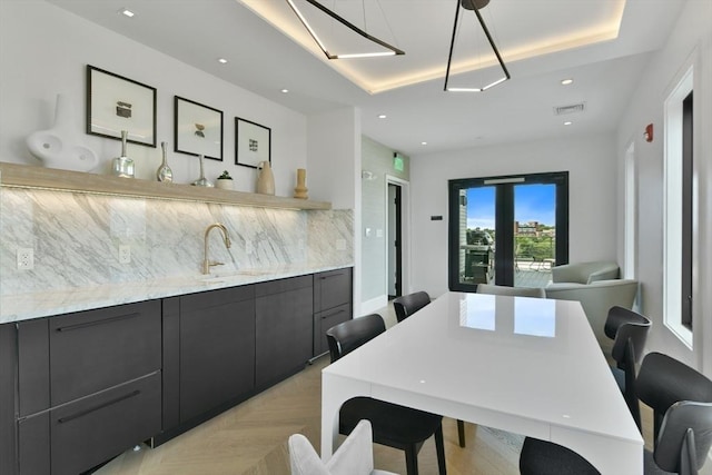 50 Leo M Birmingham Pkwy Unit 509, Boston, MA 02135 - dining space with a tray ceiling, recessed lighting, and bar with sink