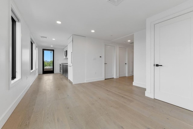 50 Leo M Birmingham Pkwy Unit 509, Boston, MA 02135 - unfurnished living room with light wood-type flooring, recessed lighting, and baseboards