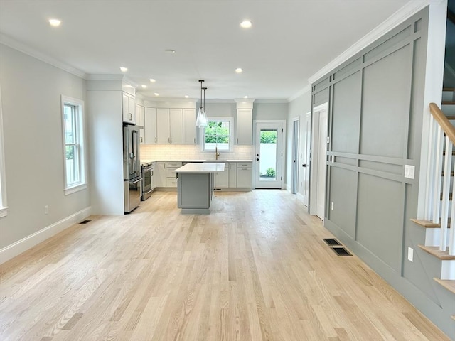 50 York Ave Unit 50, Watertown, MA 02472 - kitchen with light countertops, appliances with stainless steel finishes, tasteful backsplash, a kitchen island, and recessed lighting