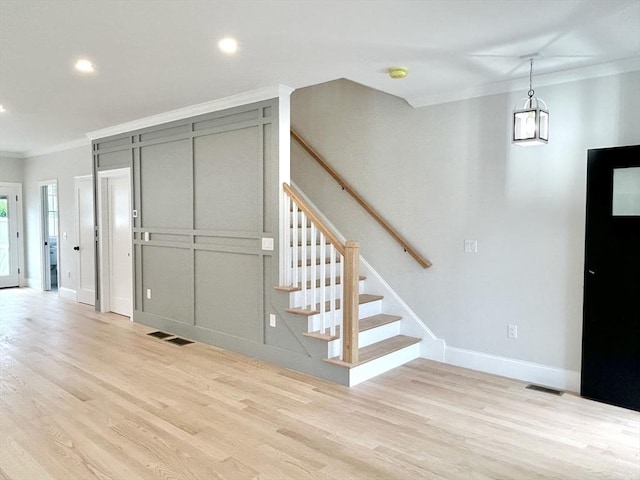 50 York Ave Unit 50, Watertown, MA 02472 - entryway with crown molding, light wood-type flooring, stairs, and recessed lighting