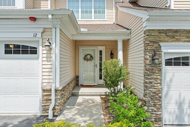 12 Bowood Ln Unit 36, Marlborough, MA 01752 - doorway to property featuring stone siding and a garage