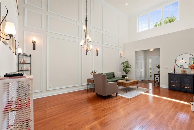 12 Bowood Ln Unit 36, Marlborough, MA 01752 - living room featuring a high ceiling, light wood-style flooring, and a decorative wall