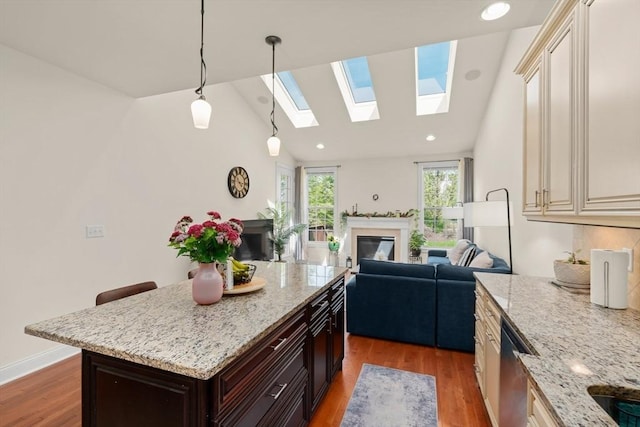 12 Bowood Ln Unit 36, Marlborough, MA 01752 - kitchen featuring cream cabinets, light wood finished floors, a skylight, open floor plan, and recessed lighting