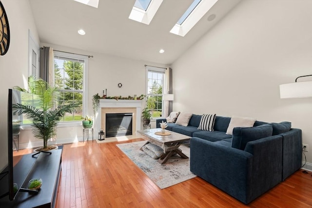 12 Bowood Ln Unit 36, Marlborough, MA 01752 - living area featuring healthy amount of natural light, a fireplace with flush hearth, a skylight, wood finished floors, and recessed lighting