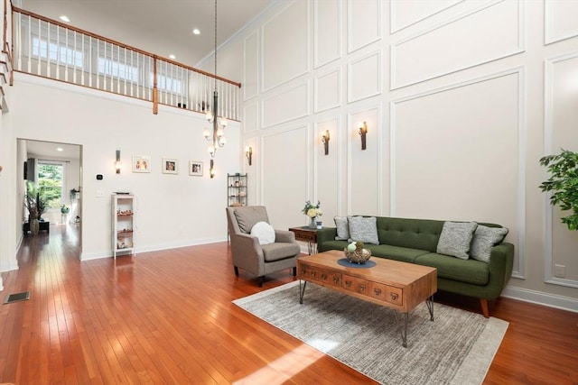 12 Bowood Ln Unit 36, Marlborough, MA 01752 - living area featuring a high ceiling, a decorative wall, and hardwood / wood-style floors
