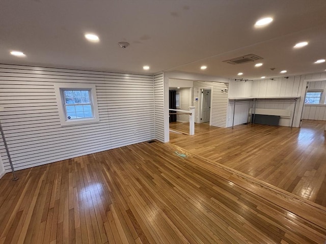 unfurnished living room featuring light wood-type flooring, visible vents, and recessed lighting