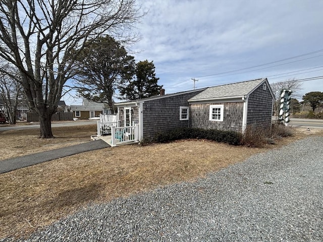 view of front of home featuring a shingled roof and a chimney