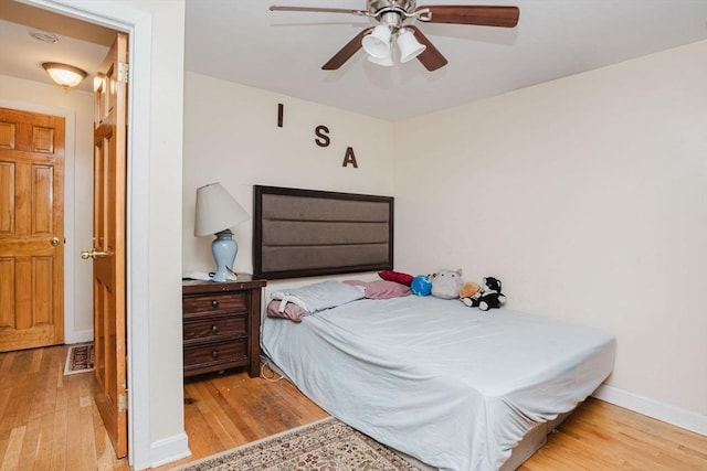 bedroom with light hardwood / wood-style floors and ceiling fan