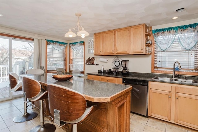 kitchen with a kitchen breakfast bar, dishwasher, sink, and a kitchen island