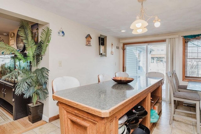 dining area with an inviting chandelier and light tile patterned floors