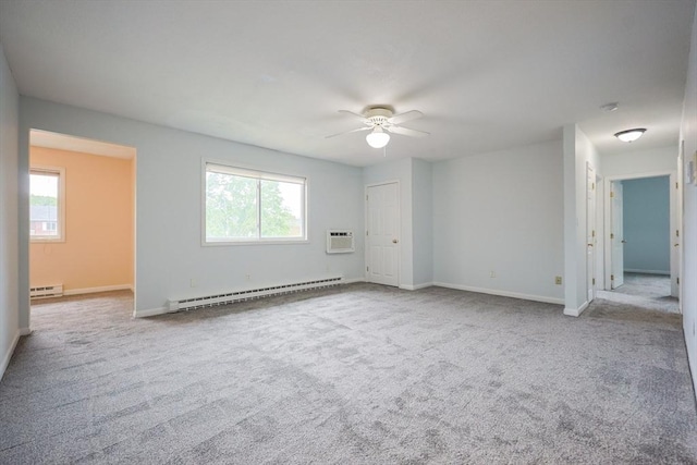 3 Dailey St Unit I, Attleboro, MA 02703 - empty room with a baseboard heating unit, ceiling fan, a wall unit AC, and plenty of natural light