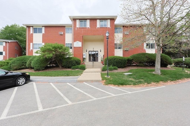 3 Dailey St Unit I, Attleboro, MA 02703 - view of front facade featuring brick siding and uncovered parking