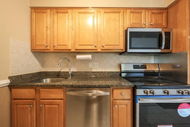 3 Dailey St Unit I, Attleboro, MA 02703 - kitchen with stainless steel appliances, a sink, decorative backsplash, and dark stone countertops
