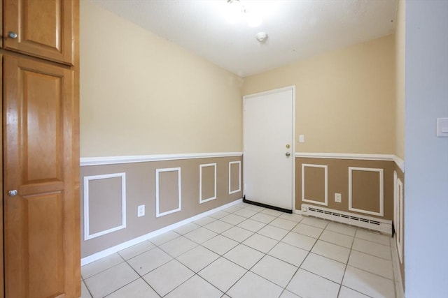 3 Dailey St Unit I, Attleboro, MA 02703 - spare room with a baseboard radiator, a wainscoted wall, and light tile patterned floors