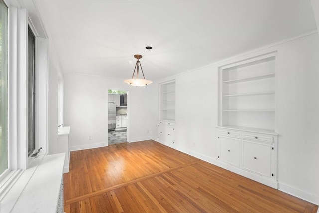 220 Prospect St, Seekonk, MA 02771 - empty room with light wood-style flooring, built in shelves, and baseboards