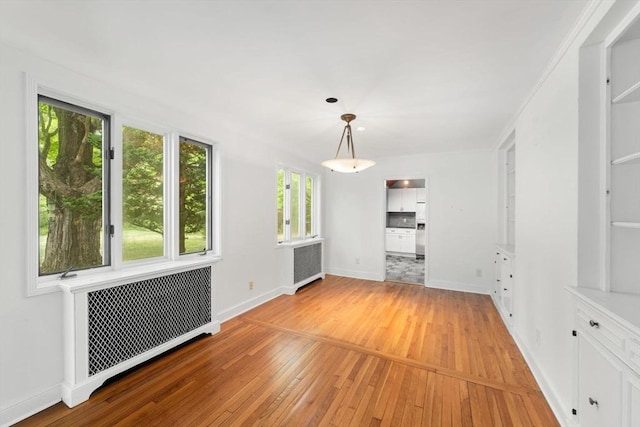 220 Prospect St, Seekonk, MA 02771 - unfurnished living room featuring radiator heating unit, light wood finished floors, and baseboards