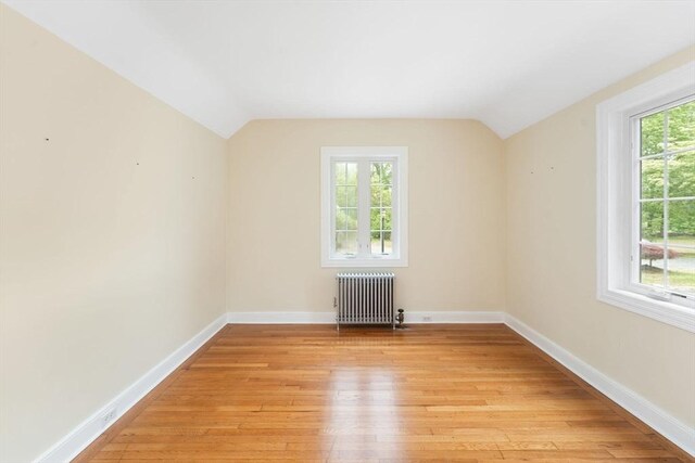 220 Prospect St, Seekonk, MA 02771 - bonus room featuring radiator, vaulted ceiling, light wood finished floors, and baseboards