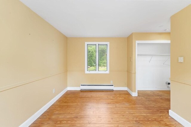 220 Prospect St, Seekonk, MA 02771 - unfurnished bedroom featuring a baseboard radiator, light wood-style floors, baseboards, and a closet