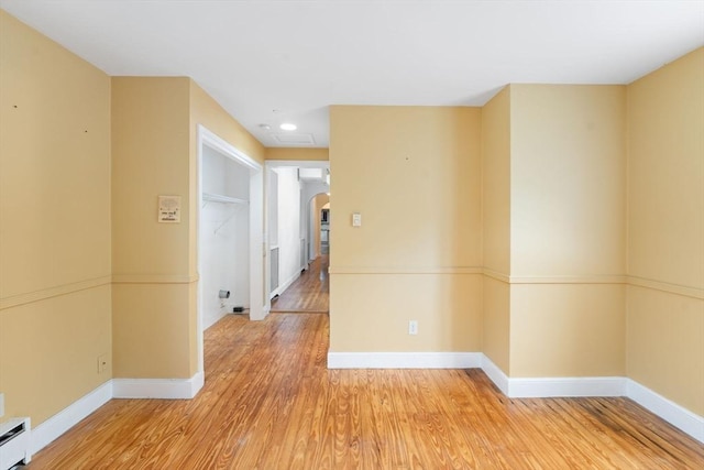 220 Prospect St, Seekonk, MA 02771 - spare room featuring arched walkways, a baseboard heating unit, wood finished floors, baseboards, and recessed lighting