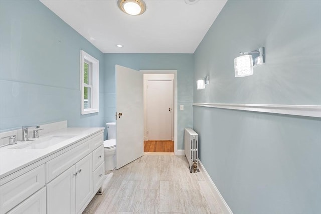 220 Prospect St, Seekonk, MA 02771 - bathroom featuring radiator heating unit, toilet, wood finished floors, vanity, and baseboards