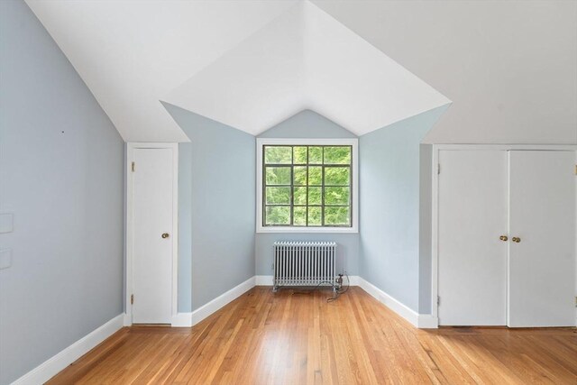 220 Prospect St, Seekonk, MA 02771 - bonus room with radiator heating unit, light wood-type flooring, vaulted ceiling, and baseboards