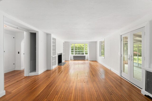 220 Prospect St, Seekonk, MA 02771 - unfurnished living room with a fireplace, hardwood / wood-style flooring, built in shelves, and baseboards