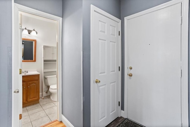 interior space featuring light tile patterned floors and baseboards